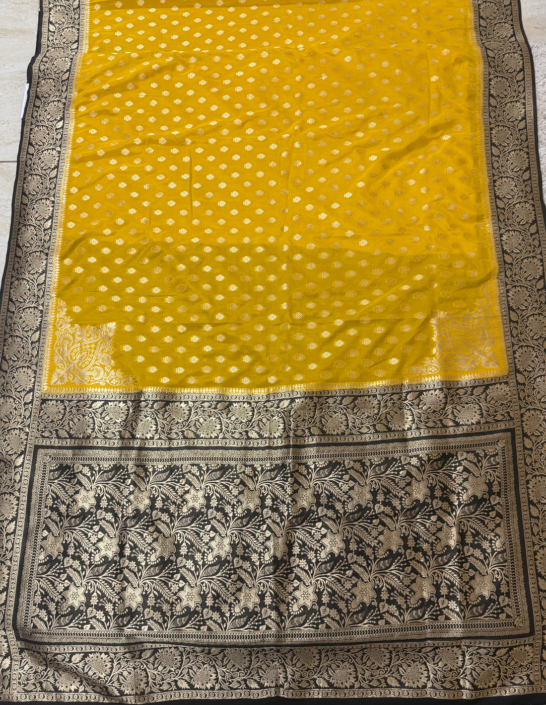 Mustard yellow Color Semi Banarasi Silk Saree with Rich Black & Gold Floral Border
